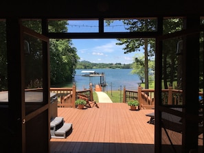 Sliding glass doors open up to amazing screened in porch and open deck