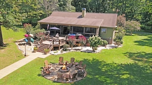 House w/ screened porch, outdoor decks and firepit area. Great yard too!