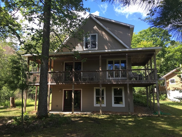 Front of house with wrap around deck on 3 sides and walkout basement.