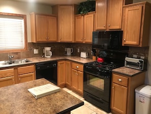 Well appointed kitchen with a coffee maker, filters and coffee provided