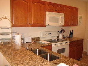 Gourmet style kitchen with granite countertops.