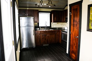 Furnished kitchen with the basics, open to the dining area.