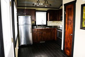 Furnished kitchen with the basics, open to the dining area.