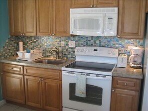 Updated kitchen with granite countertops, new cabinets, and new appliances.