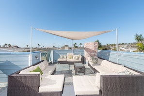 Wonderfully appointed rooftop deck with ample seating and dining areas, BBQ grill and panoramic views of the ocean and surrounding area.
                
