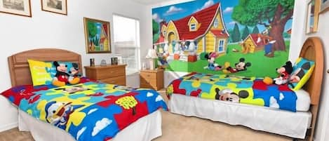 Disney themed kids room. 2 twin beds. with attached bathroom