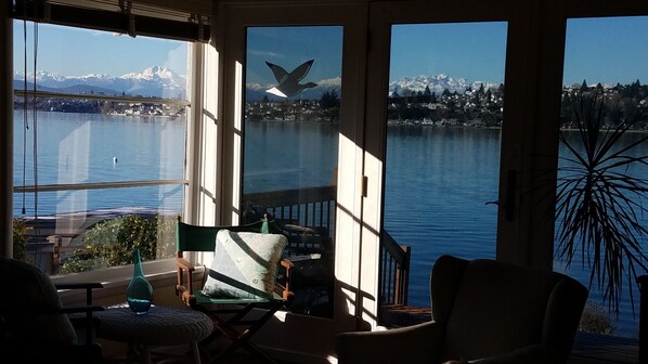 Large windows and 3 panel glass door to deck capture full views from Living Room