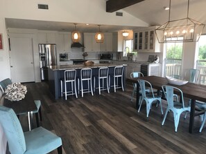 The dining area with seating for 8 at the table, 4 at the bar