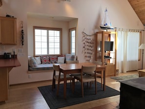 Dining table with window alcove behind it.  A great place to curl up with a book