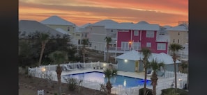 Pool with Pink 🦩Flamingo Beach House in the background.