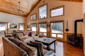 The views from the gorgeous two-story windows are breath-taking. There are views of the white-capped mountains as well as the surrounding forest.