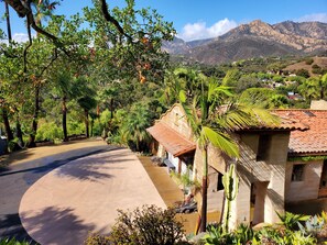 House seen from above. Mountain backdrop.