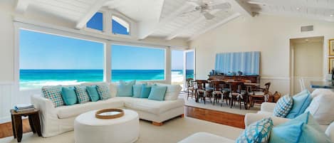 Relax and enjoy the view from the beautiful living room steps from the sand