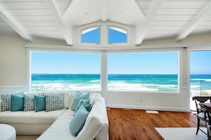 Large windows and accordion-style doors bring the ocean to you
