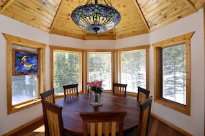 Incredible south facing 5-window turret dining room w/ custom table & lighting