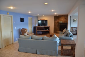 Fireplace and 55 inch TV highlight the huge family room