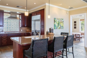 Chef's open kitchen with additional counter seating