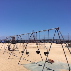 Swings in front of grass