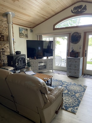 Living room, 65' TV, leather reclining couch, 2 recliners