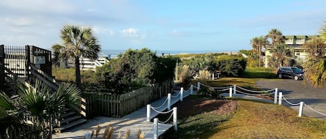 View from deck overlooking lush landscaping and ocean. Short steps to soft sand!