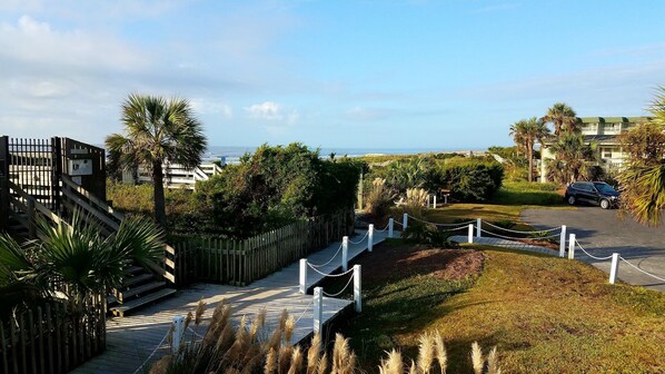 View from deck overlooking lush landscaping and ocean. Short steps to soft sand!