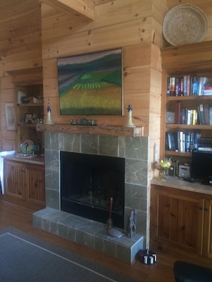 Wood burning fireplace with wet bar to the left.