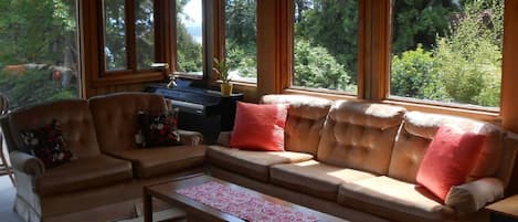 Summer fun playing the piano in the sunroom with vaulted ceilings and skylight.