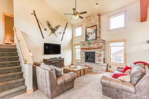 relax in the large living area with fireplace and 60 inch TV