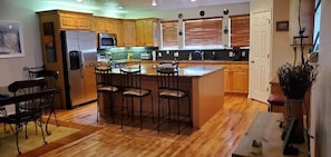 Large inviting kitchen, hardwood floors, granite countertops, all utensils