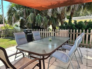 Wonderful fully shaded outdoor dining with BBQ grill in pet friendly fenced yard