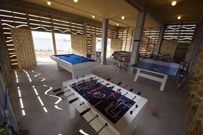 Game room with pool table, foos ball, ping pong, shower, hot tub, bikes & games.