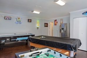 Game room with access to outside, pool area, large refrigerator