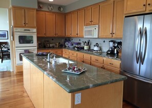 Great kitchen for visiting with friends while cooking. Overlooks backyard