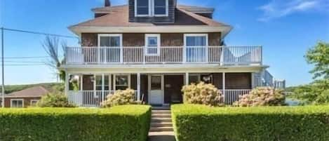 Front of house.  First and second floor decks visible.