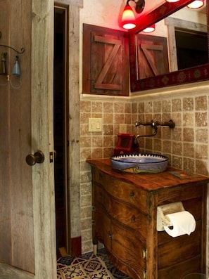 second bathroom with travertine and river rock shower