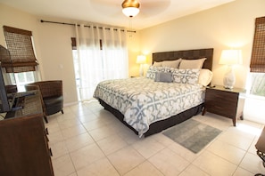 Master Bedroom with walk-out access to poolside lounge-chairs. 