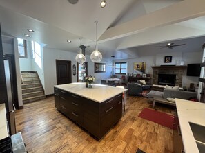 Kitchen, dining room and family room with gas fireplace.
