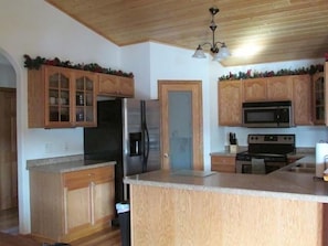 Kitchen is fully equipped and beautifully appointed with open concept.