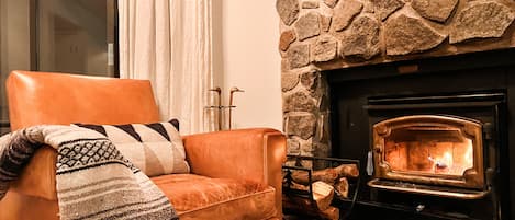 Cozy up to the wood burning fireplace in vintage leather chairs