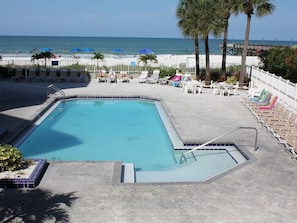 Heated Pool area with Beach chairs and leading to the Beach
