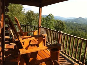 Tall adirondack chairs to see over railing.