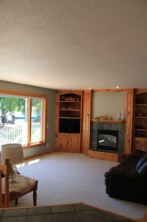 Family room with gas fireplace and TV and dvd player.