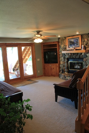 Lower level family room with fabulous views of lake and TV and fireplace.