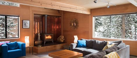 The open-plan living room/dining room with woodstove is the heart of the house