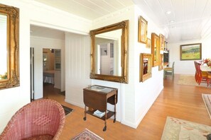 The view of the living room to the hall where the 2nd bedroom & half bath is or if you wish to upgrade to a 3rd bedroom it would be adjacent. The full bathroom is just around this corner. 