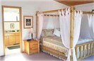 Master Bedroom, canopy bed and full bath with mountain views from bed.