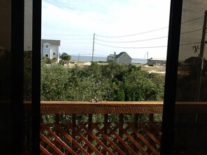 View through master b/r sliding door w/ocean in background (3 min walk to beach)