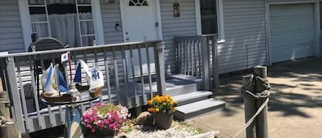 Entrance from parking area; small deck with grill right outside of the kitchen.