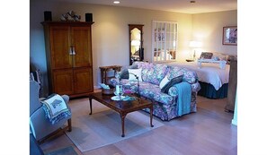 Sitting area with comfy king bed in background.