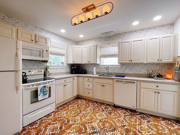 streamline open kitchen with hand stenciled hardwood floors